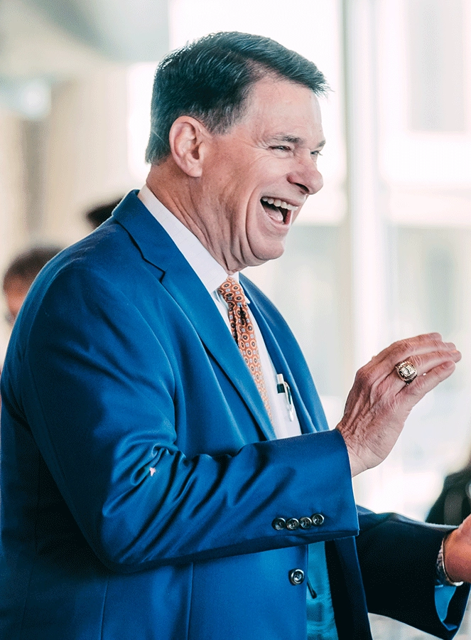 Broker/Owner Dewey Mitchell smiling at event