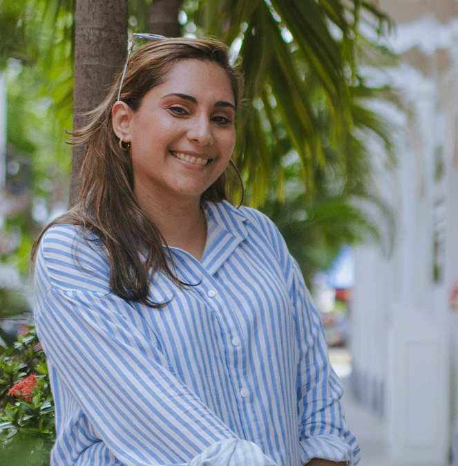 hispanic female property manager wearing striped blouse outside